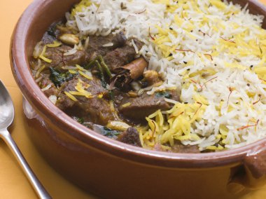 Pot of Lamb Biryani with a spoon clipart