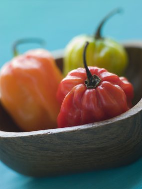 Scotch Bonnet Chilies In a Wooden Dish clipart