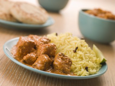 Plated Chicken Korma with Pilau Rice and Naan bread clipart