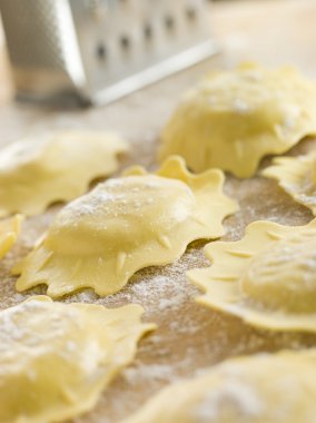 Close up of Uncooked Spinach and Ricotta Ravioli on a floured surface clipart