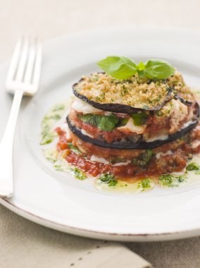 Plate of Aubergine Parmigiana Tower with Herb Oil clipart