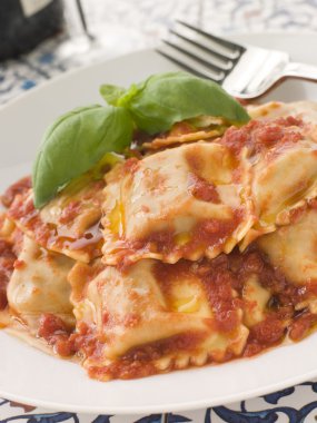 Plate of Veal and Sage Ravioli with Tomato and Basil Sauce clipart