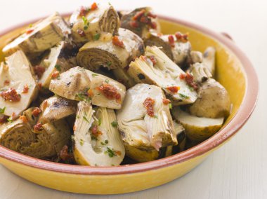 Bowl of Marinated Baby Artichoke Salad with Sun Dried Tomatoes clipart