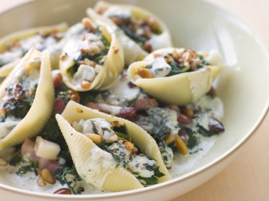 Conchiglioni pasta shells with Spinach Pancetta Pine Nuts and Go clipart