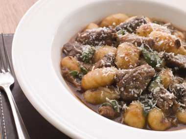 Oxtail Braised in Red Wine with Basil Gnocchi and Parmesan Chees clipart