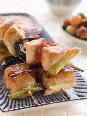 Plate of Yakitori Skewers with Sukiyaki Sauce and Rice Crackers clipart