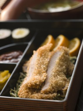 Close up of Tonkatsu Box and Miso Soup with Pickles and Sushi clipart