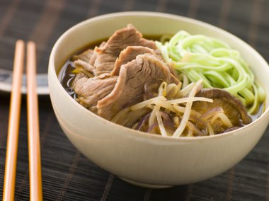 Bowl of Hot and Sour Beef Broth With Spinach Ramen Noodles clipart