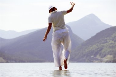 Young woman walking in lake clipart