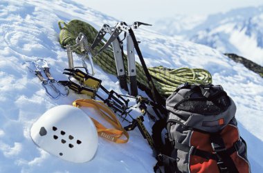 Mountain climbing equipment in snow clipart
