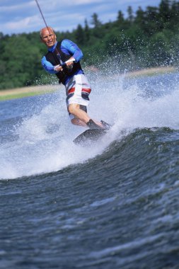 A young man water skiing clipart