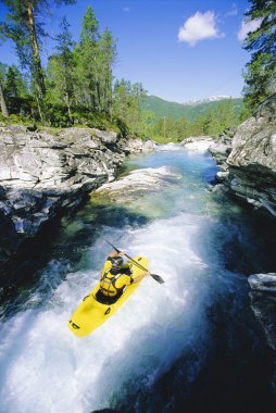 Young man kayaking in river clipart