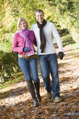 Young couple on autumn walk clipart