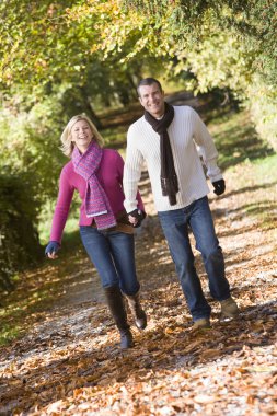 Couple holding hands on walk clipart