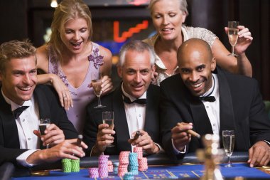 Group of friends gambling at roulette table