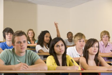 College student with hand raised in university lecture hall clipart