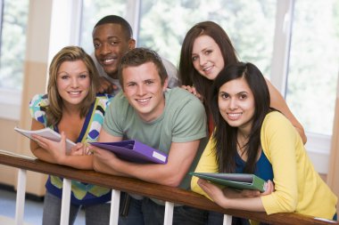 Group of college students leaning on banister clipart