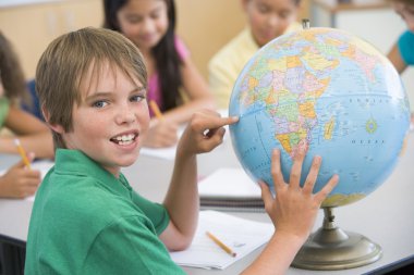 Elementary school pupil in geography lesson clipart