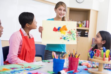 Elementary school pupil in art class clipart