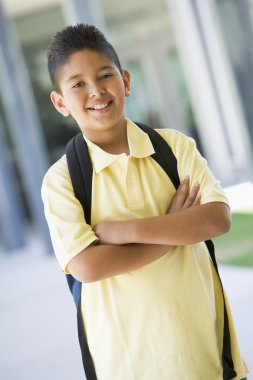 Elementary school pupil outside with backpack clipart