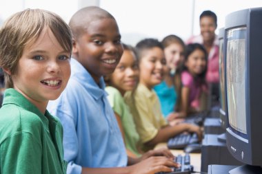 Elementary school computer class looking at camera clipart