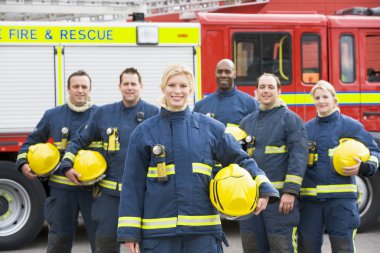 Portrait of a group of firefighters by a fire engine clipart