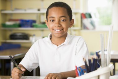 A schoolboy studying in class clipart