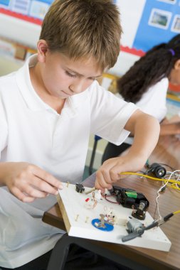 A schoolboy in a science class clipart