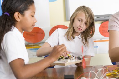 Schoolgirls in a science class clipart