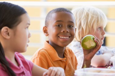 Kindergarten children eating lunch clipart