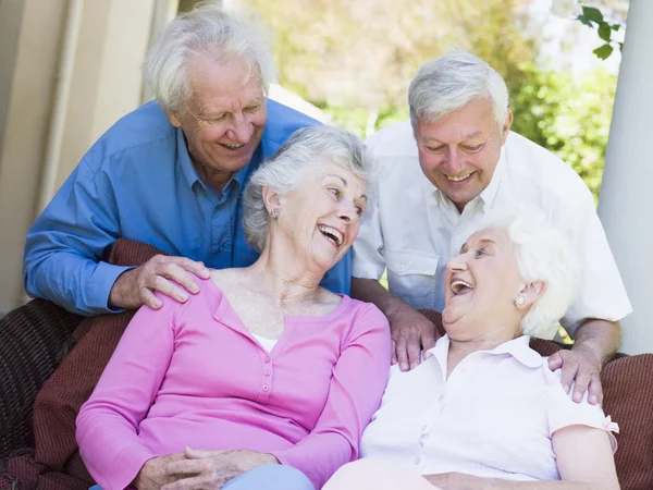 Group Senior Friends Sitting Garden Seat Laughing — Stock Photo, Image