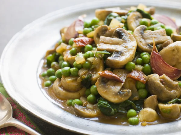 Mushroom and Pea Curry with Roasted Garlic on a Pewter Plate — Stock Photo, Image