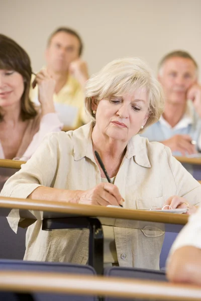 stock image Senior woman listening to a university lecture