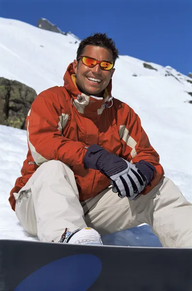 Молодий чоловік відпочиває від сноубордингу — стокове фото