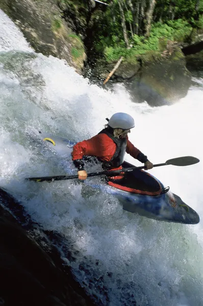 Young woman kayaking down waterfall — Stock Photo, Image