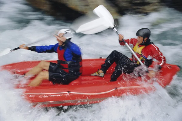 Two paddling inflatable boat down rapids — Stock Photo, Image