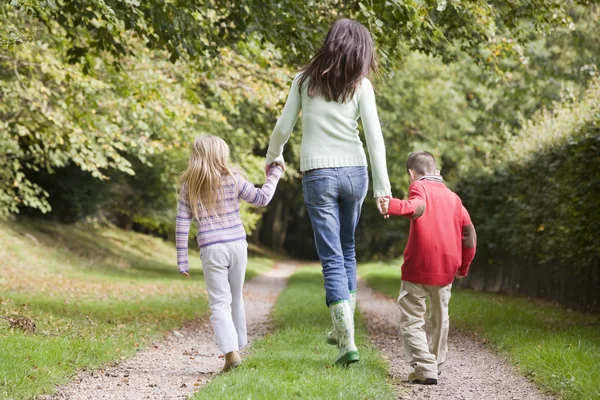 母亲和儿童在秋天走在林地路径 — 图库照片