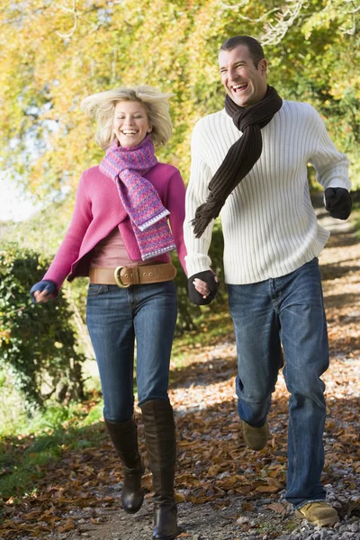Young Couple Running Autumn Woodland Path — Stock Photo, Image