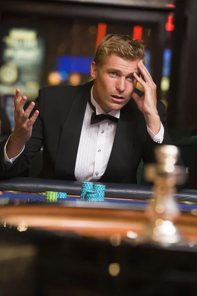 stock image Man losing at roulette table