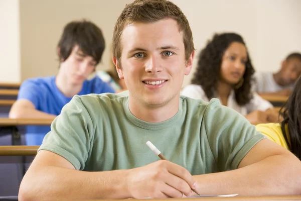 Male college student in a university lecture hall — Stock Photo, Image