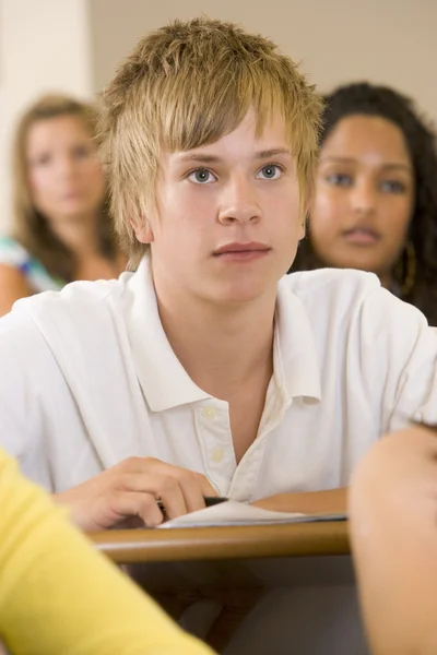 Male college student listening to a university lecture — Stock Photo, Image