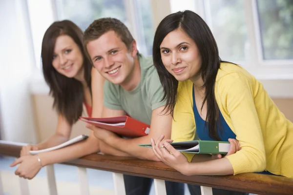 Three college students leaning on banister — Stock Photo, Image