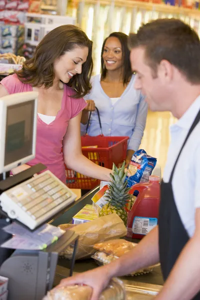 Woman paying for groceries - Stock Image - Everypixel