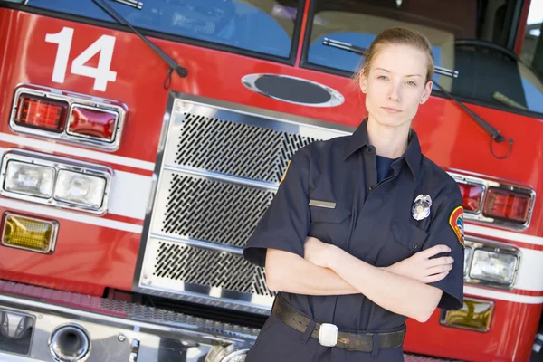 Portrait of a firefighter by a fire engine — Stock Photo, Image