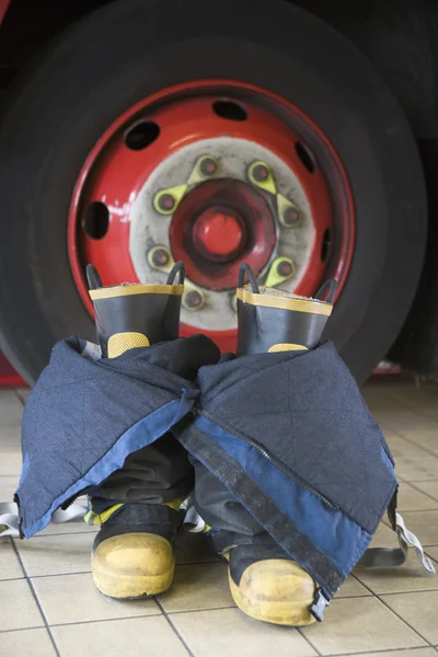 stock image Firefighter's boots and trousers in a fire station