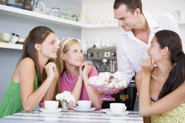 Cafe Waiter Offers Young Women Teacakes — Stockfoto