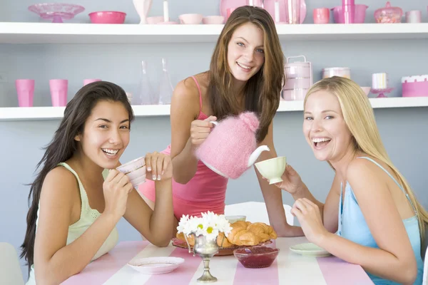 Three young women in their underwear having a tea party — Stock Photo, Image
