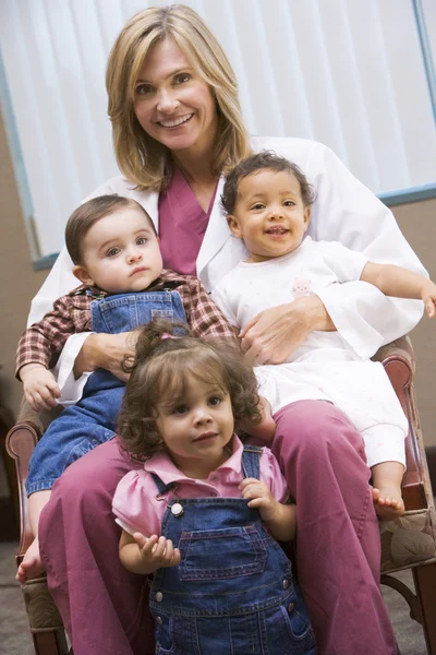 Consultant Holding Three Ivf Conceived Children — Stock Photo, Image