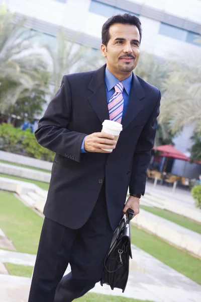 stock image Businessman walking to work with coffee