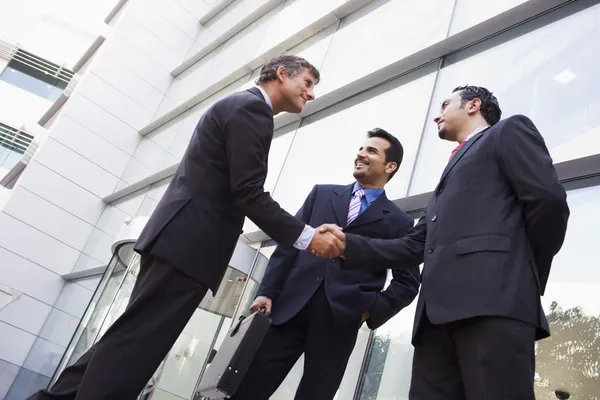 Business shaking hands outside office — Stock Photo, Image
